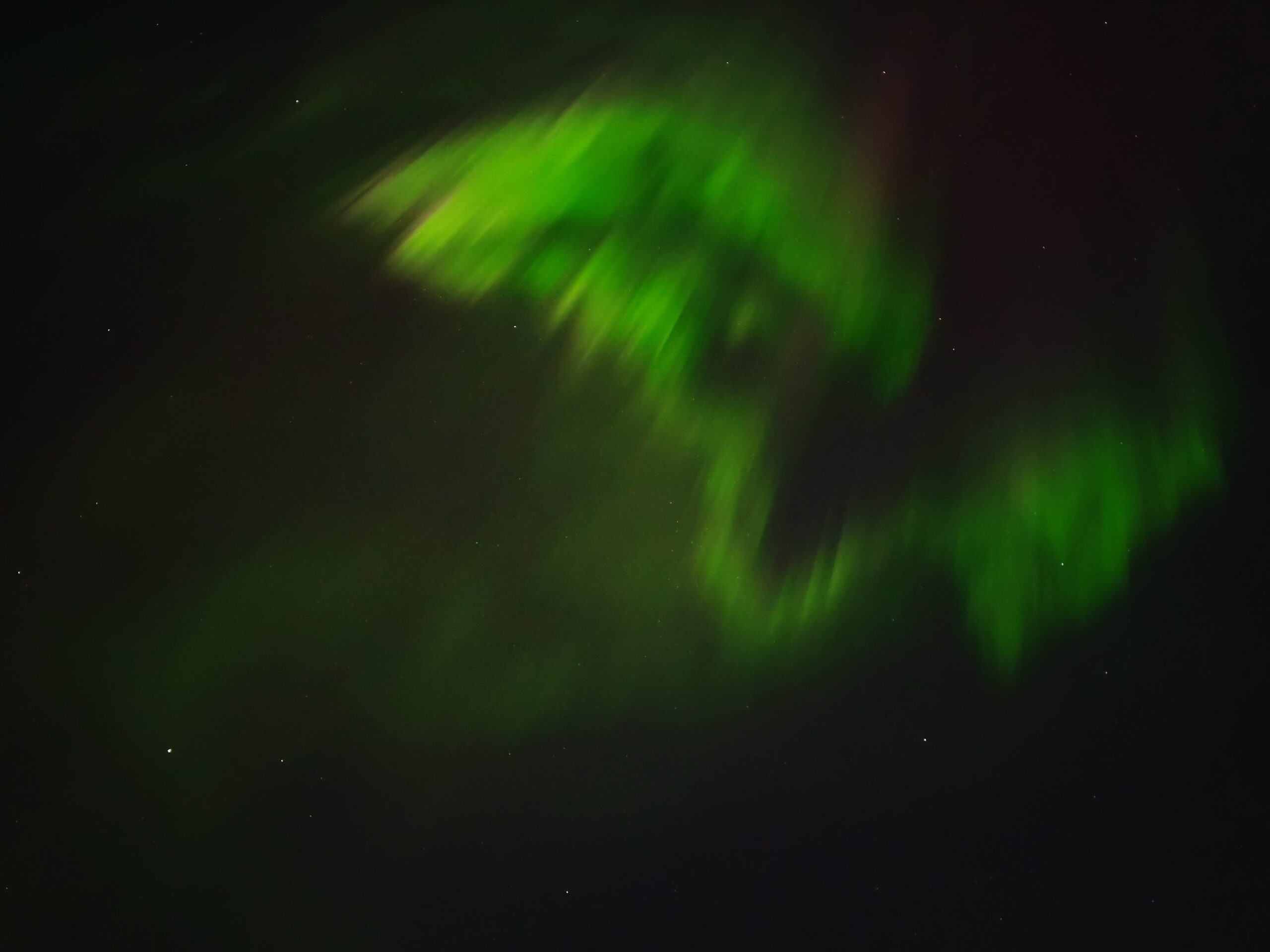 Aurora as pictured by my phone, with bright greens and a hint of red